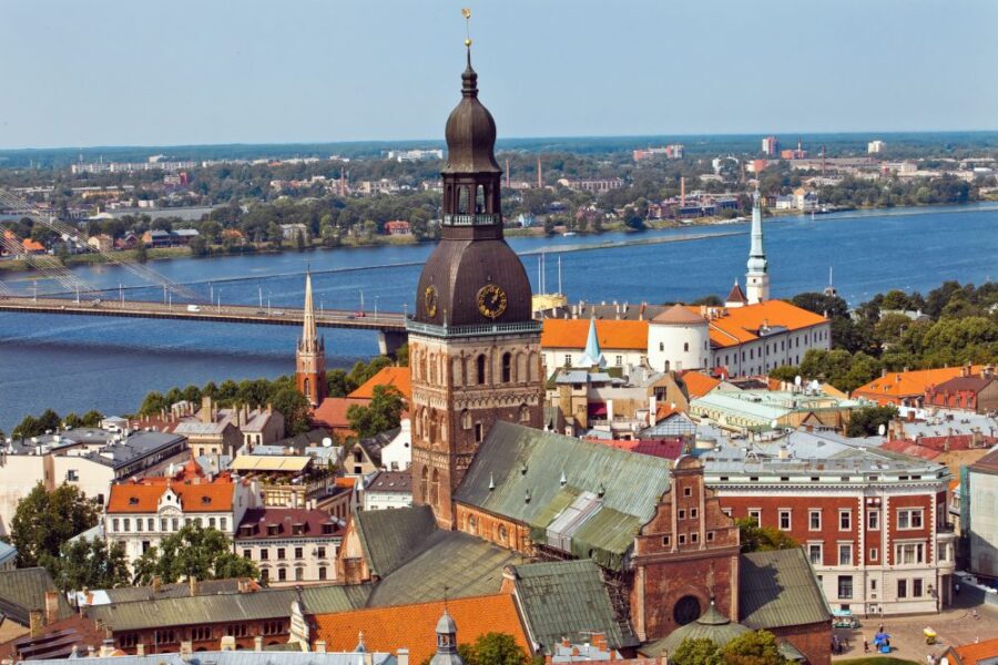 Majestic Riga Cathedral, with its towering spire and historic architecture, dominates the city skyline. A view of this iconic landmark.