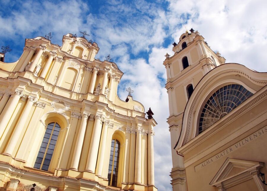 St. John the Baptist and St. John the Apostle and Evangelist Church at Vilnius University, featuring Baroque architecture and a cloudy sky.