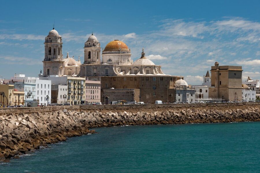 The Cadiz Cathedral in Spain, showcasing its stunning baroque and neoclassical architecture under a clear blue sky.