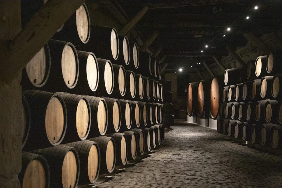 Traditional port wine barrels in a cellar in Porto, Portugal.