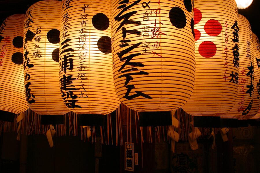 Traditional Japanese lanterns hanging in Tokyo, Japan, illuminating the night with warm, inviting light.