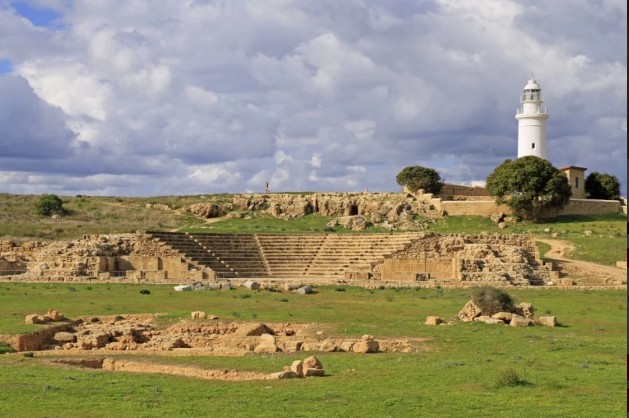 Ancient ruins in Paphos, Cyprus, featuring stone structures and a cloudy sky.
